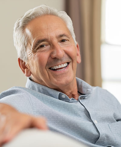 Senior man smiling at home